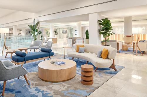 a lobby with couches and chairs and a table at Le Meridien Lav Split in Podstrana