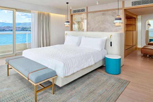 a bedroom with a large bed and a large window at Le Meridien Lav Split in Podstrana
