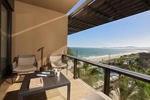 a balcony with a view of the beach at JW Marriott Los Cabos Beach Resort & Spa in San José del Cabo
