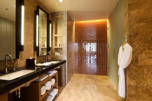 a bathroom with a shower and a sink and a mirror at JW Marriott Los Cabos Beach Resort & Spa in San José del Cabo
