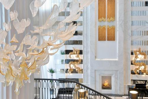a large chandelier in a room with a fireplace at The St. Regis Amman in Amman