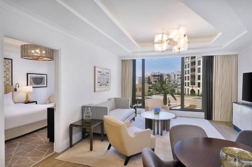 a living room with a bed and a dining room at The St. Regis Amman in Amman