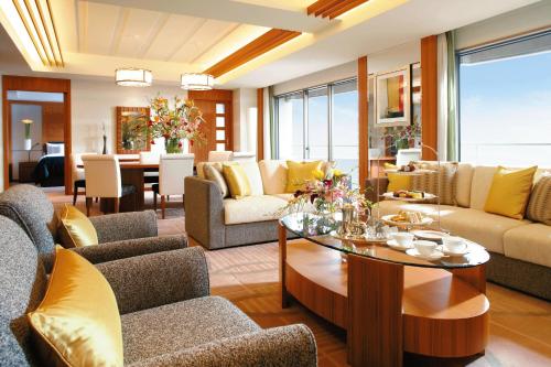 a living room with couches and a table at Sheraton Grande Tokyo Bay Hotel in Urayasu