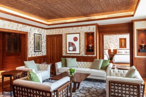 a living room with furniture and a bed at The St. Regis Saadiyat Island Resort, Abu Dhabi in Abu Dhabi