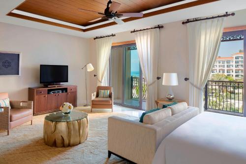 a large living room with a bed and a tv at The St. Regis Saadiyat Island Resort, Abu Dhabi in Abu Dhabi