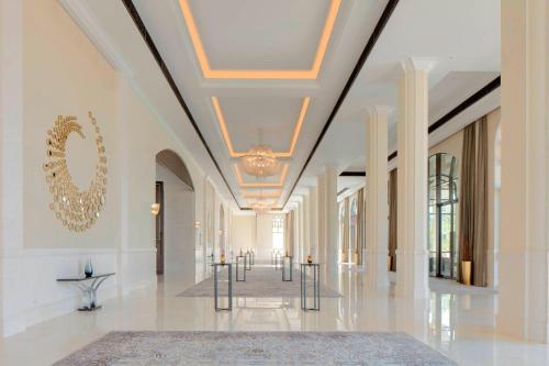 a hallway of a building with a chandelier at The St. Regis Saadiyat Island Resort, Abu Dhabi in Abu Dhabi