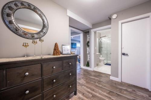 a bathroom with a dresser and a mirror on the wall at Cozy Chic Oasis 3 Bedroom in Halifax