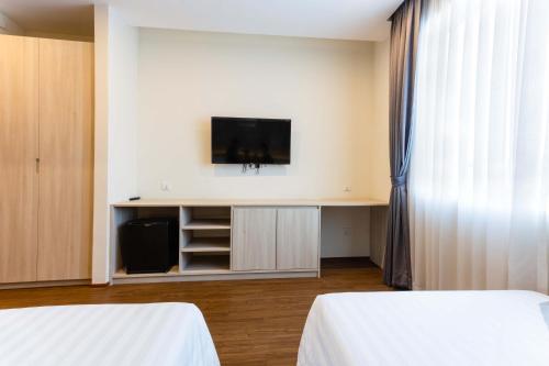Ένα ή περισσότερα κρεβάτια σε δωμάτιο στο Joli Hotel