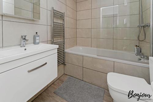 a bathroom with a toilet and a tub and a sink at Mabillon Suite - Gorgeous-Haymarket, City Centre-FREE Parking by Bonjour Residences Edinburgh in Edinburgh