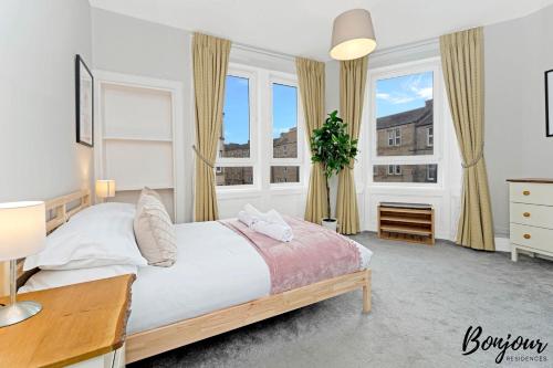 a bedroom with a large bed and two windows at Mabillon Suite - Gorgeous-Haymarket, City Centre-FREE Parking by Bonjour Residences Edinburgh in Edinburgh