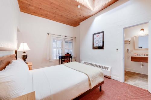 a bedroom with a white bed and a window at The Historic Taos Inn in Taos