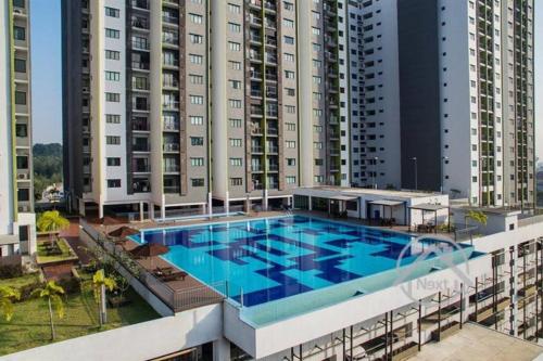 a large swimming pool on top of a building with tall buildings at Homestay Shah Alam (Residensi Alami) in Shah Alam
