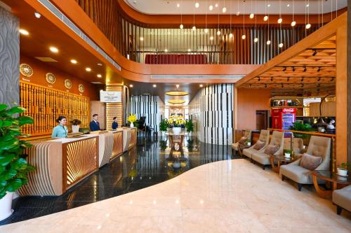 a lobby of a hotel with people sitting at a bar at Muong Thanh Grand Saigon Centre Hotel in Ho Chi Minh City