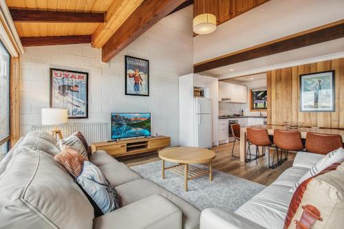 a living room with a couch and a table at Fountains 3 in Mount Hotham