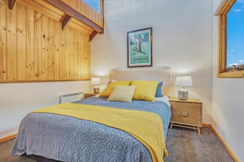 a bedroom with a bed and a window at FOUNTAINS 3, Mount Hotham in Mount Hotham