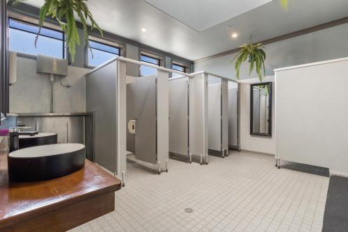 a large bathroom with stalls in a building at The Great Western Hotel in Orange