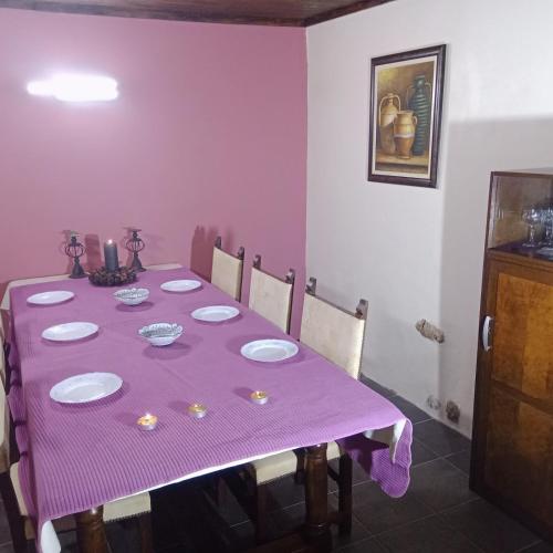 a purple table with a purple table cloth on it at Casa Amoreira - Quinta Amoreira in Faro