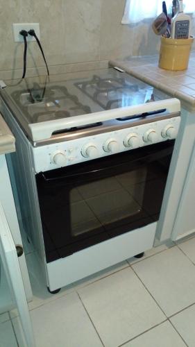 a stove top oven sitting in a kitchen at Lynn's Cozy Cottage in Nassau