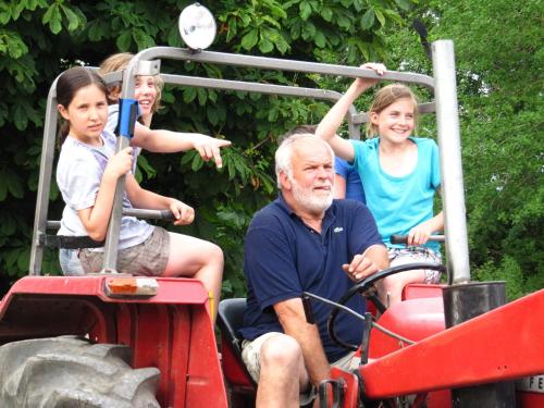a group of people riding on the back of a tractor at Ferienhof Utech in Wenkendorf auf Fehmarn