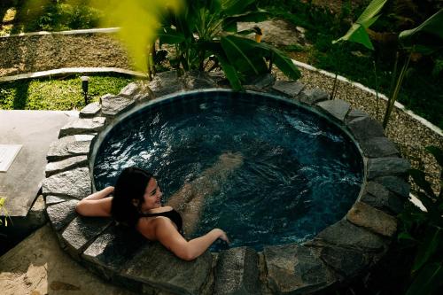 a woman sitting in a pool of water at 150 Peakway Mountain Resort in Dalaguete
