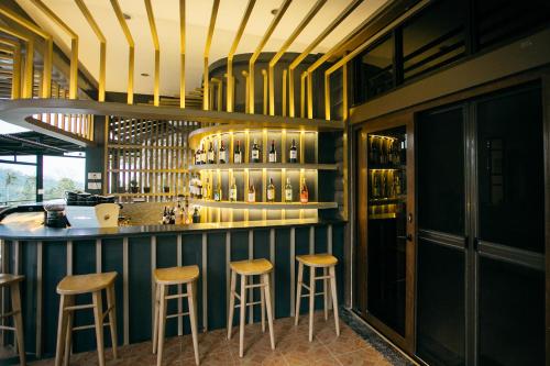 a bar in a restaurant with stools at a counter at 150 Peakway Mountain Resort in Dalaguete