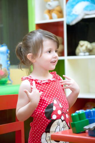 a little girl in a red polka dot dress at Novotel Solo in Solo