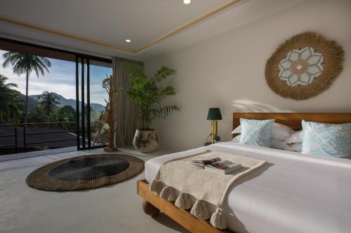 a bedroom with a large bed and a large window at Villa L3 by Stay Samui - Bohemian Chic in Koh Samui 