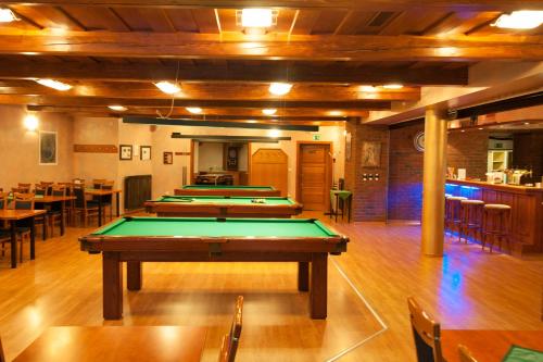 a row of pool tables in a room at Sport-V-Hotel in Hrotovice