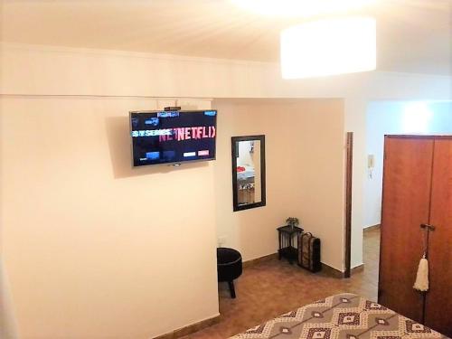 a room with a flat screen tv on the wall at Barrio Norte hermoso apart privado in San Miguel de Tucumán