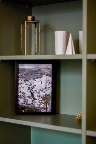 a shelf with a picture of a city on it at - Le Manon !Gare - topappartnancy in Nancy