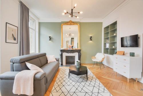 a living room with a couch and a fireplace at - Le Manon !Gare - topappartnancy in Nancy