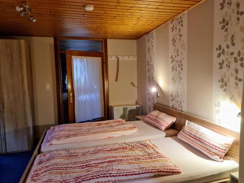 una camera con due letti con cuscini sopra di Ferienappartement Persang GbR a Eppenbrunn