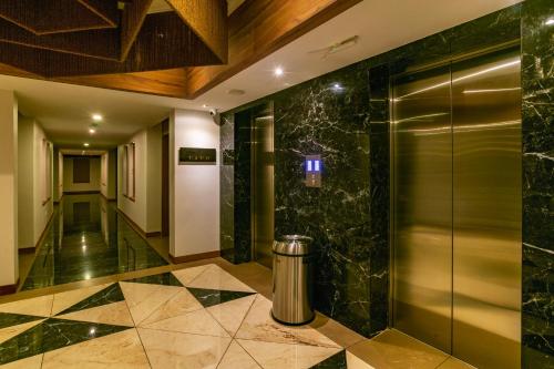 a lobby with a elevator in a building at Classic Regency in Alleppey