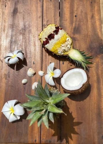 a table with a piece of cake and flowers on it at Sea Sand Resort in Kalpitiya
