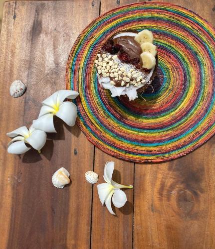 a plate of food on a wooden table with flowers at Sea Sand Resort in Kalpitiya