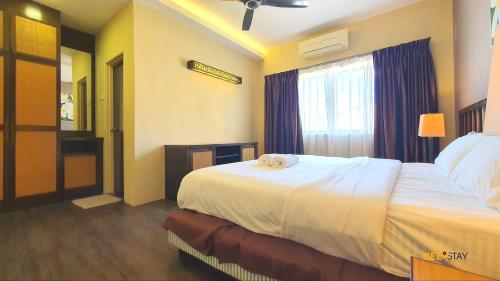 a hotel room with a bed and a window at Gold Coast Morib Studio l Apartment I Penthouse in Banting