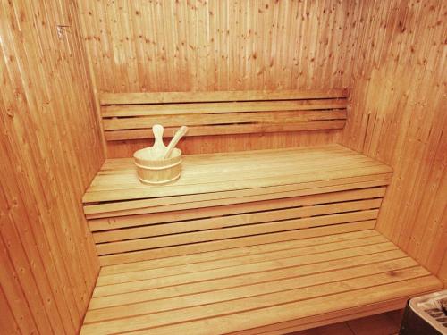 a wooden sauna with a wooden bucket in it at Five-Bedroom Holiday home in Jelsa 2 in Jelsa