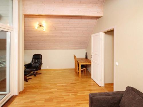 a living room with a table and chairs and a door at Holiday Home Foreneset in Jelsa