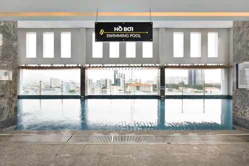 a swimming pool with a sign in a building at Muong Thanh Grand Saigon Centre Hotel in Ho Chi Minh City
