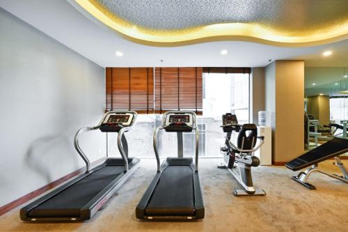 a gym with two treadmills and two exercise bikes at Muong Thanh Grand Saigon Centre Hotel in Ho Chi Minh City