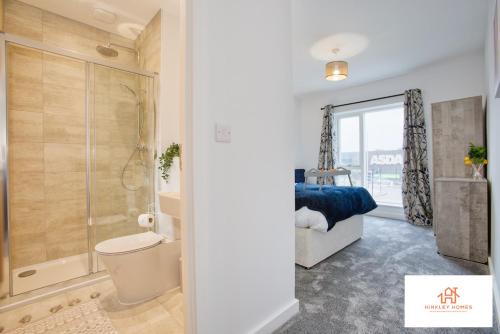 a bathroom with a shower and a bedroom with a bed at St Ives Bay - Immaculate Brand New 3Bed - Free Parking - Beach - WiFi in Hayle
