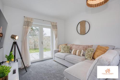 a living room with a couch and a window at St Ives Bay - Immaculate Brand New 3Bed - Free Parking - Beach - WiFi in Hayle