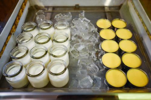 a tray of milk and cheese in a container at Muong Thanh Grand Saigon Centre Hotel in Ho Chi Minh City