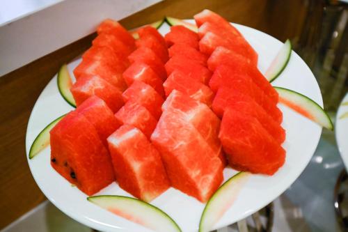 a plate of watermelon slices on a table at Muong Thanh Grand Saigon Centre Hotel in Ho Chi Minh City