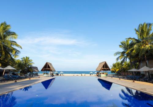 a swimming pool on the beach at a resort at Maalu Maalu Resort & Spa - Thema Collection in Pasikuda