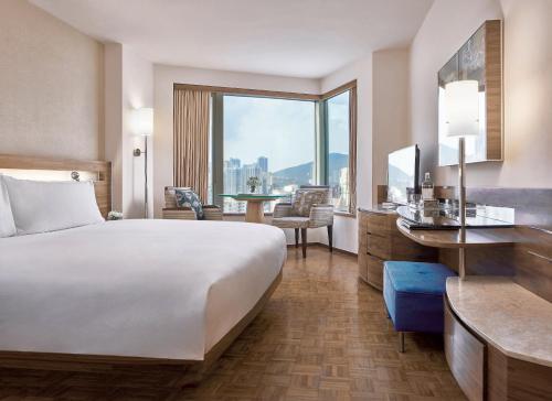 a hotel room with a large bed and a large window at Nina Hotel Causeway Bay in Hong Kong