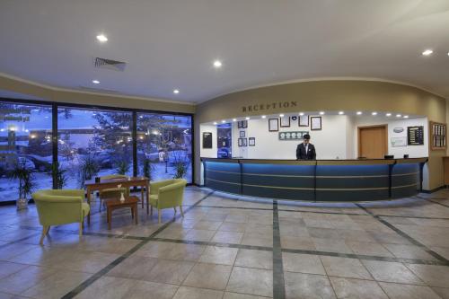 a man standing in the lobby of a hotel at Palan Ski & Convention Resort Hotel in Erzurum