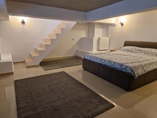 a bedroom with a bed and a staircase with rugs at Danube in Brăila