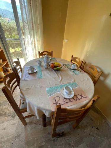 a dining room table with a bowl of fruit on it at Tonia’s house in Leonidion