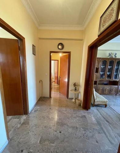 a room with a hallway with a clock on the wall at Tonia’s house in Leonidion